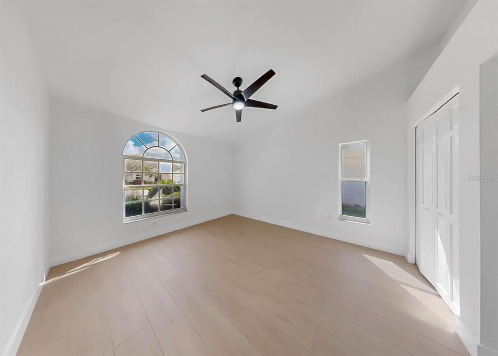 6409 Stone River Road Bradenton, FL 34203 - Photo 55 of 72 an empty room with windows and ceiling fan