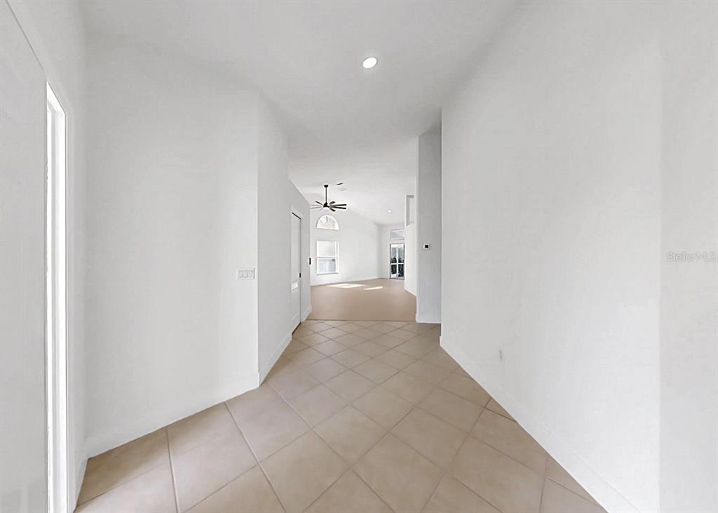 6409 Stone River Road Bradenton, FL 34203 - Photo 6 of 72 a view of a hallway with white walls