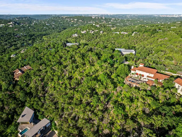 an aerial view of a houses with a yard
