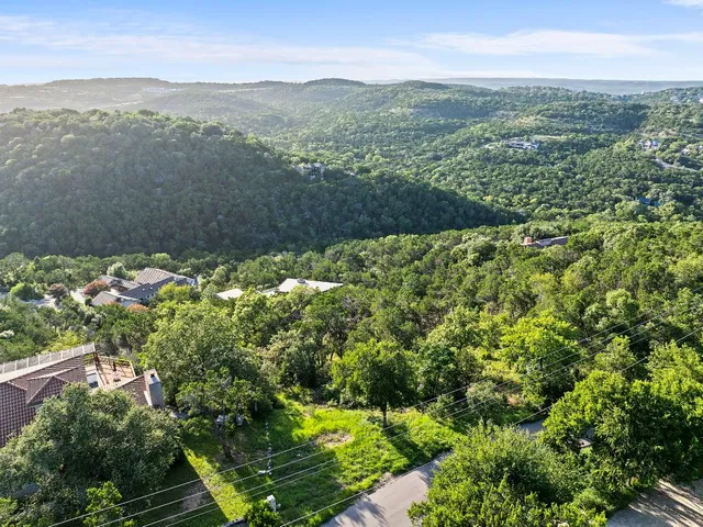 a view of a green field with lots of bushes