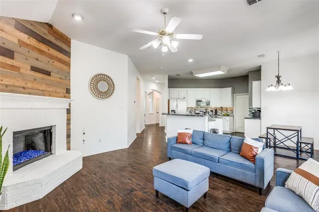a living room with furniture kitchen view and a fireplace