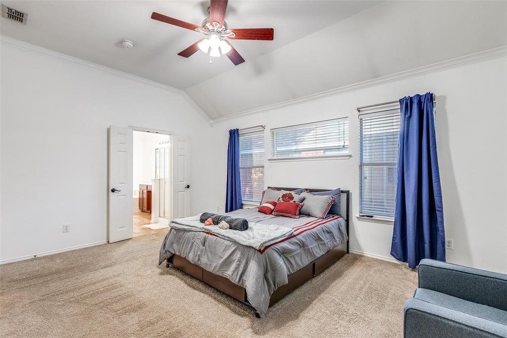 11146 Clearstream Lane Frisco, TX 75035 - Photo 16 of 28 a bedroom with a bed and a chandelier