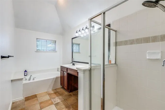 a bathroom with a tub sink and mirror