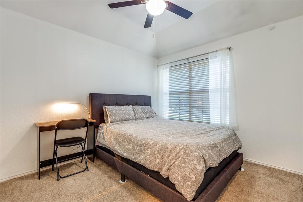 11146 Clearstream Lane Frisco, TX 75035 - Photo 19 of 28 a bedroom with a bed lamp and a window