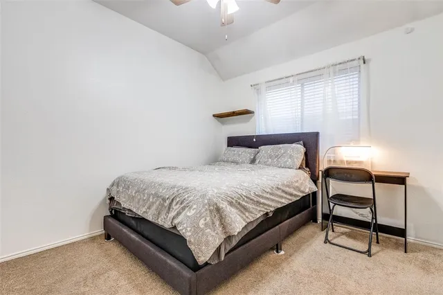 a bedroom with a bed and a lamp