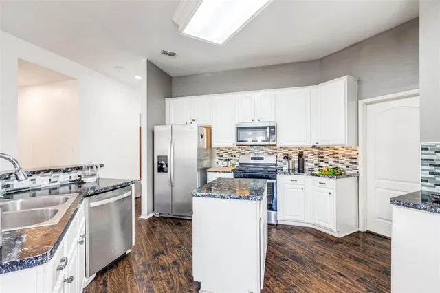 a kitchen with stainless steel appliances a refrigerator stove and sink