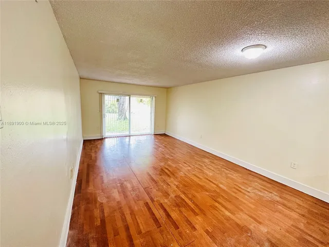 a view of an empty room and wooden floor