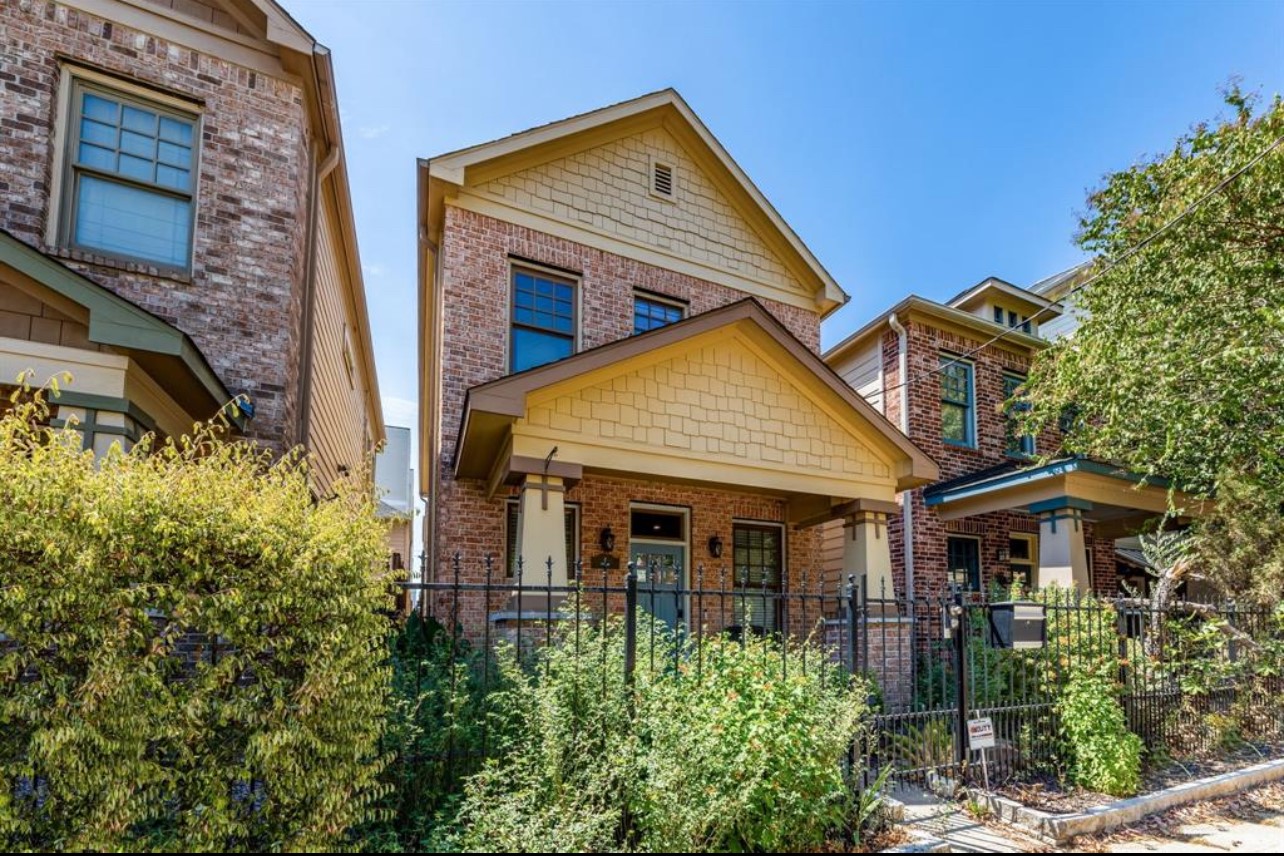 a view of a house with brick walls and plants