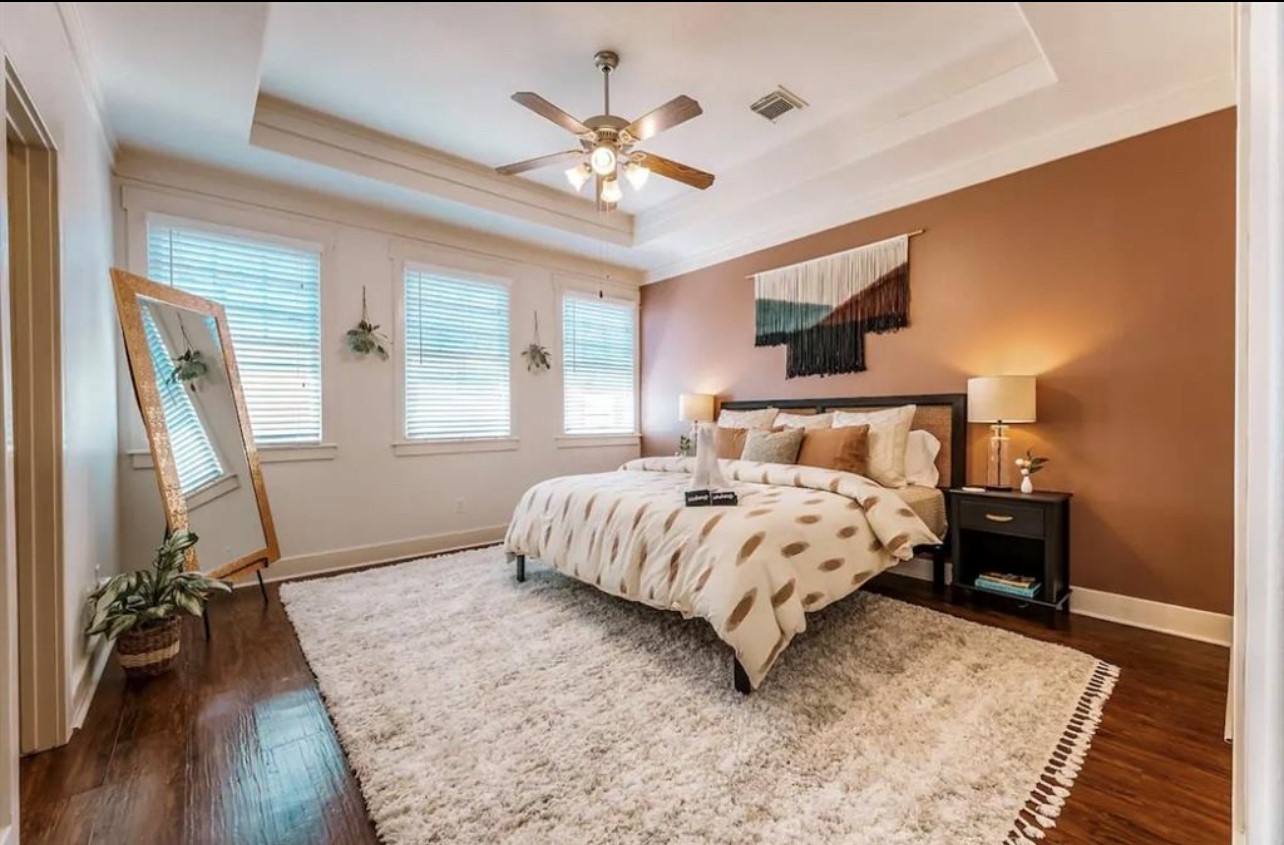 5303 Nett Street, Unit A Houston, TX 77007 - Photo 11 of 23 a bedroom with a bed and a table with wooden floor
