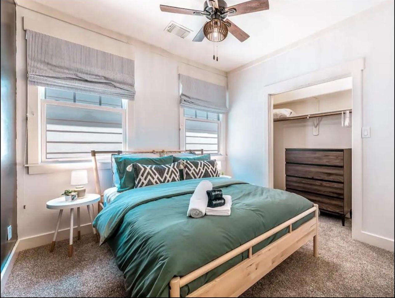 5303 Nett Street, Unit A Houston, TX 77007 - Photo 16 of 23 a bed sitting in a bedroom next to a window