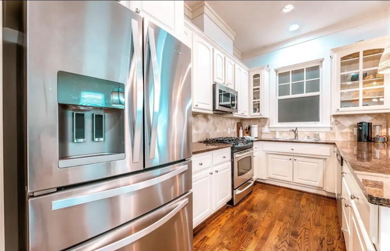 5303 Nett Street, Unit A Houston, TX 77007 - Photo 9 of 23 a kitchen with stainless steel appliances granite countertop a stove and a sink