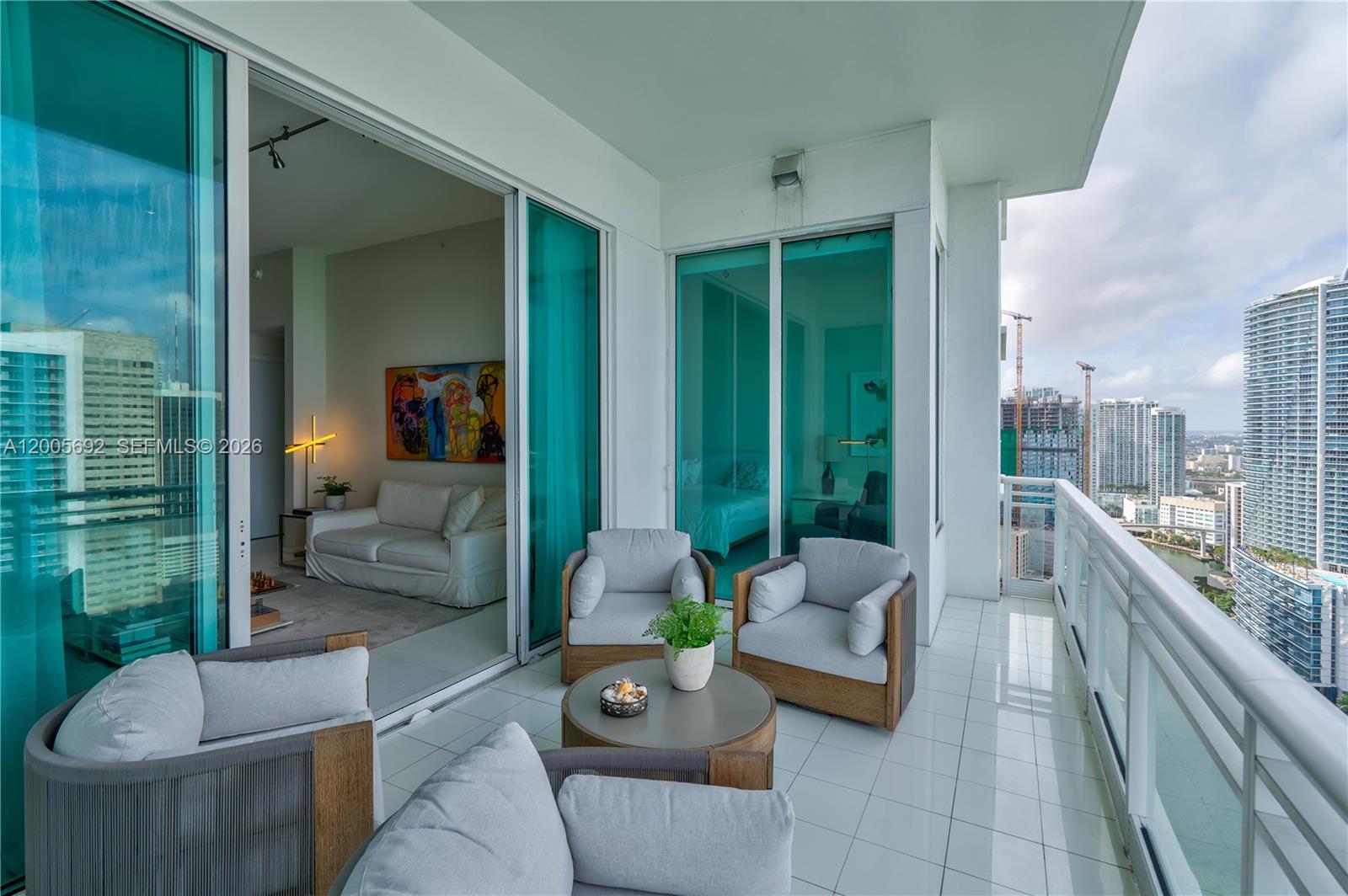900 Brickell Key Boulevard, Unit 3002 Miami, FL 33131 - Photo 14 of 47 a living room with furniture and a large window