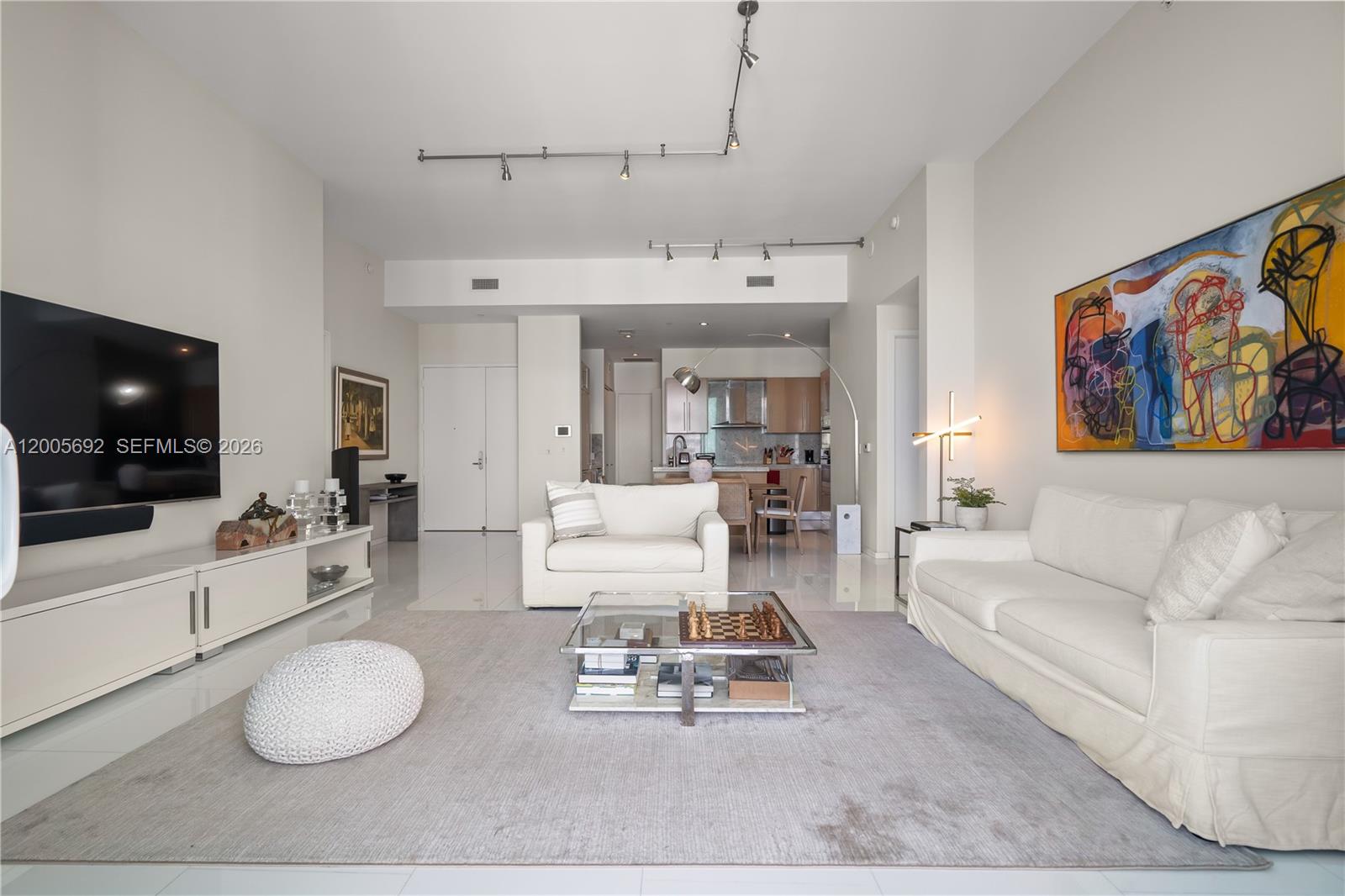 900 Brickell Key Boulevard, Unit 3002 Miami, FL 33131 - Photo 17 of 47 a living room with furniture and a flat screen tv