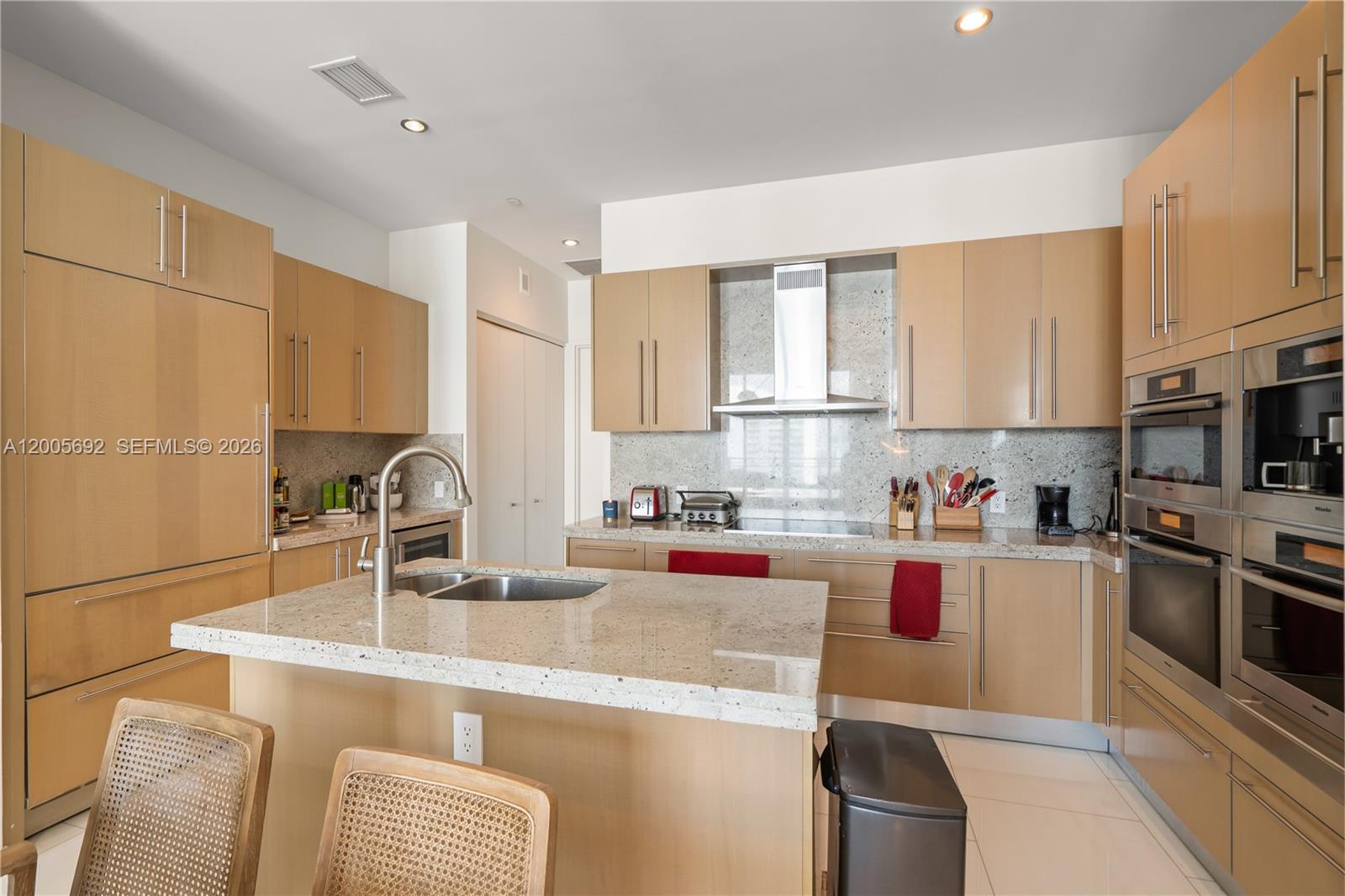 900 Brickell Key Boulevard, Unit 3002 Miami, FL 33131 - Photo 20 of 47 a kitchen with stainless steel appliances granite countertop a sink stove and refrigerator