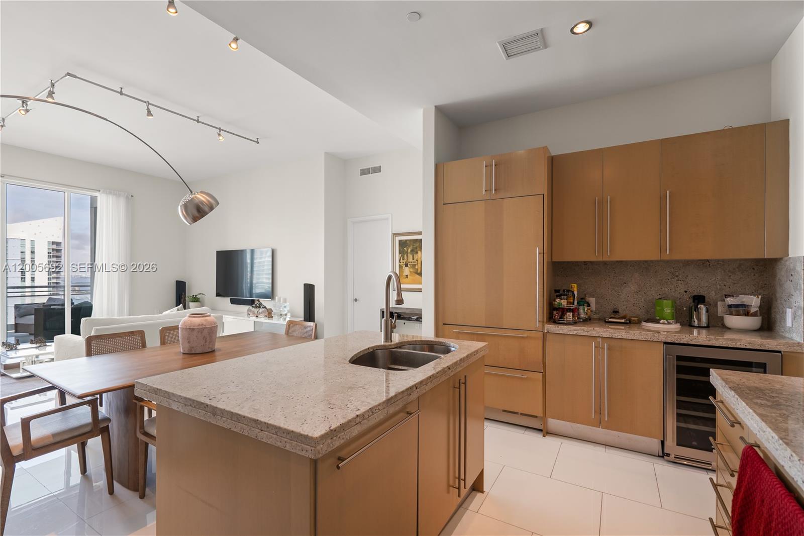 900 Brickell Key Boulevard, Unit 3002 Miami, FL 33131 - Photo 21 of 47 a kitchen with a stove cabinets and counter space