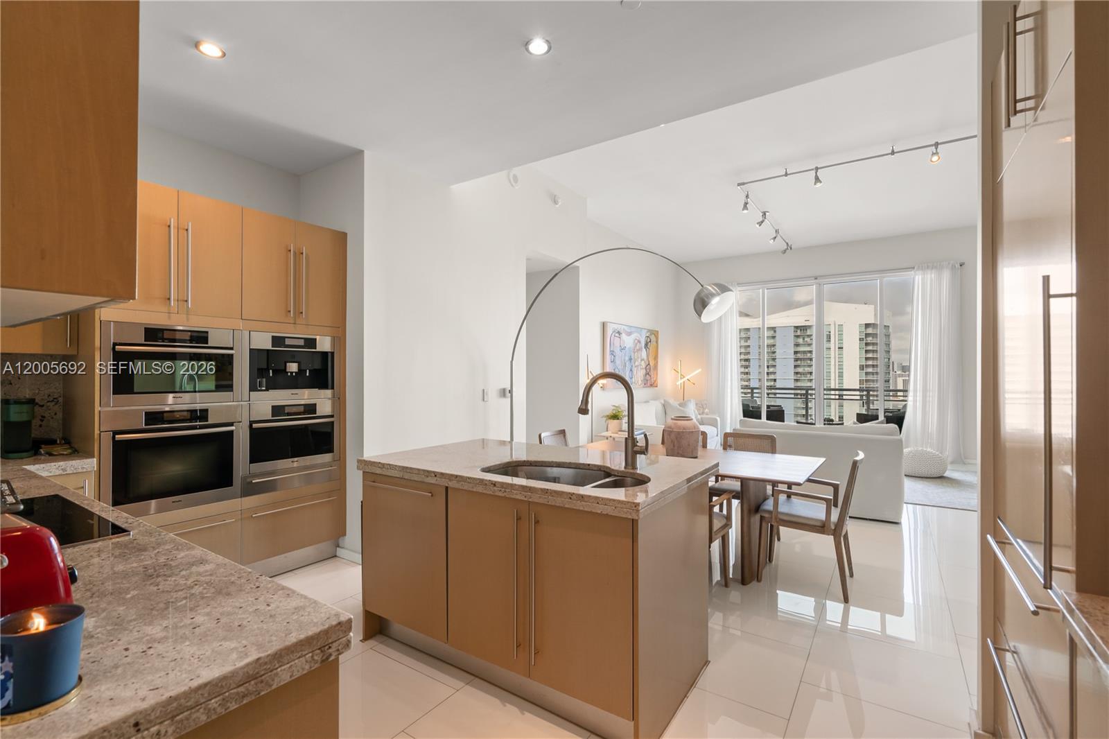 900 Brickell Key Boulevard, Unit 3002 Miami, FL 33131 - Photo 22 of 47 a kitchen with stainless steel appliances granite countertop a stove a sink and a refrigerator