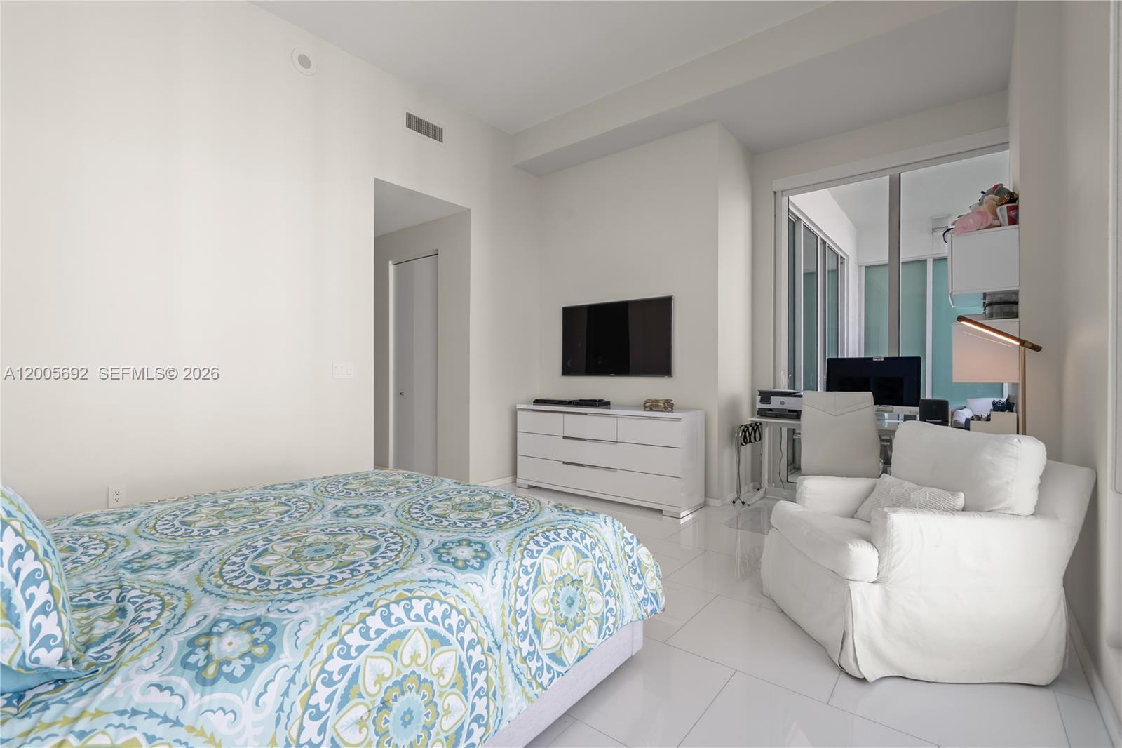 900 Brickell Key Boulevard, Unit 3002 Miami, FL 33131 - Photo 27 of 47 a bedroom with a bed and a flat screen tv