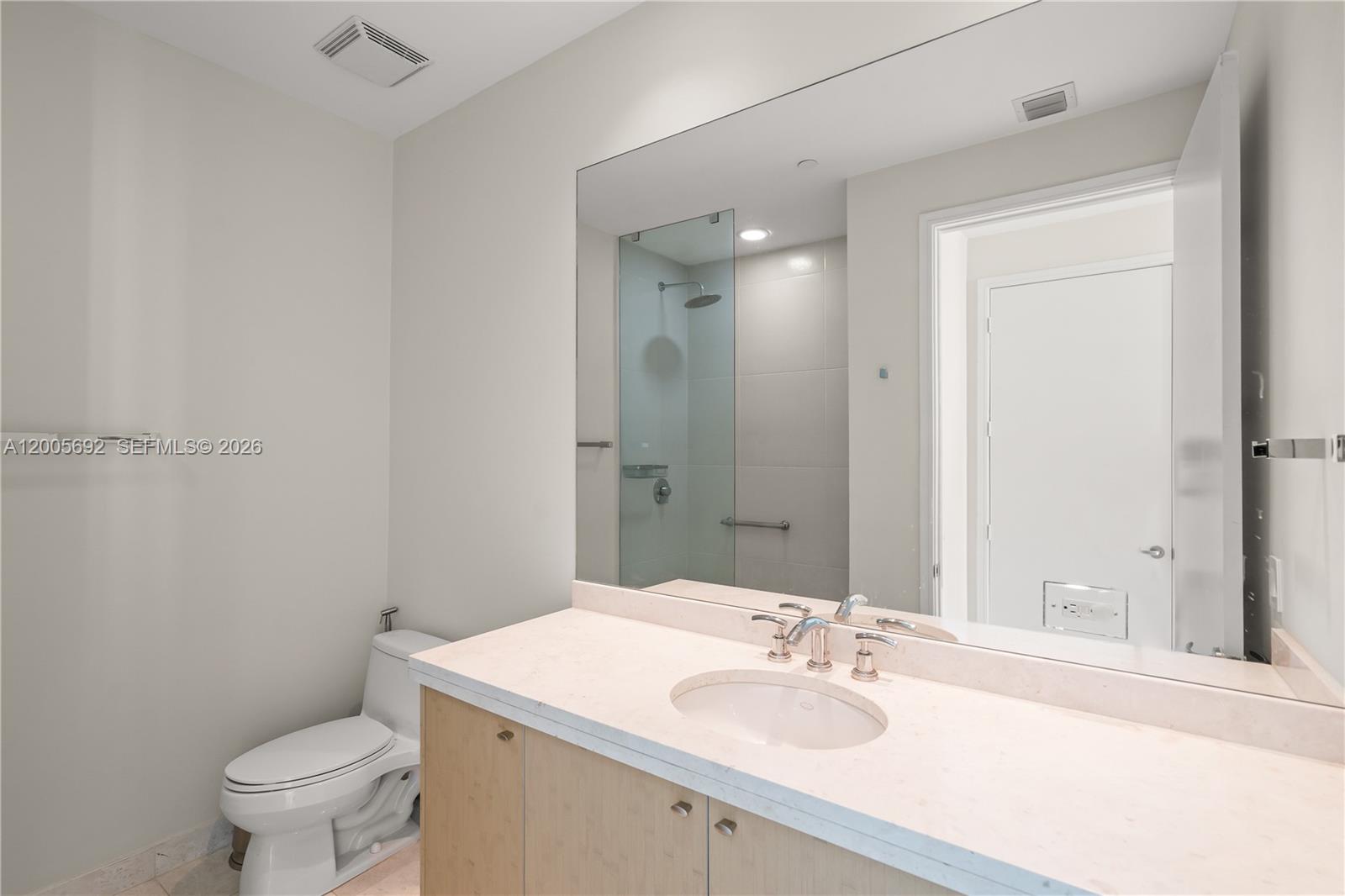 900 Brickell Key Boulevard, Unit 3002 Miami, FL 33131 - Photo 35 of 47 a bathroom with a sink toilet vanity and shower