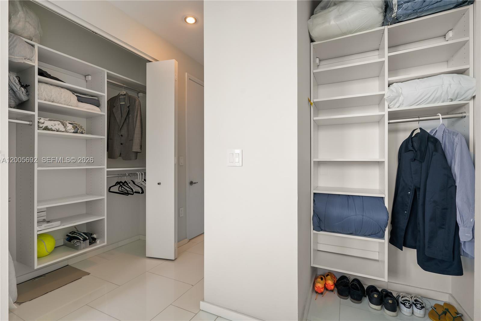 900 Brickell Key Boulevard, Unit 3002 Miami, FL 33131 - Photo 36 of 47 a view of walk in closet with clothes and shoes