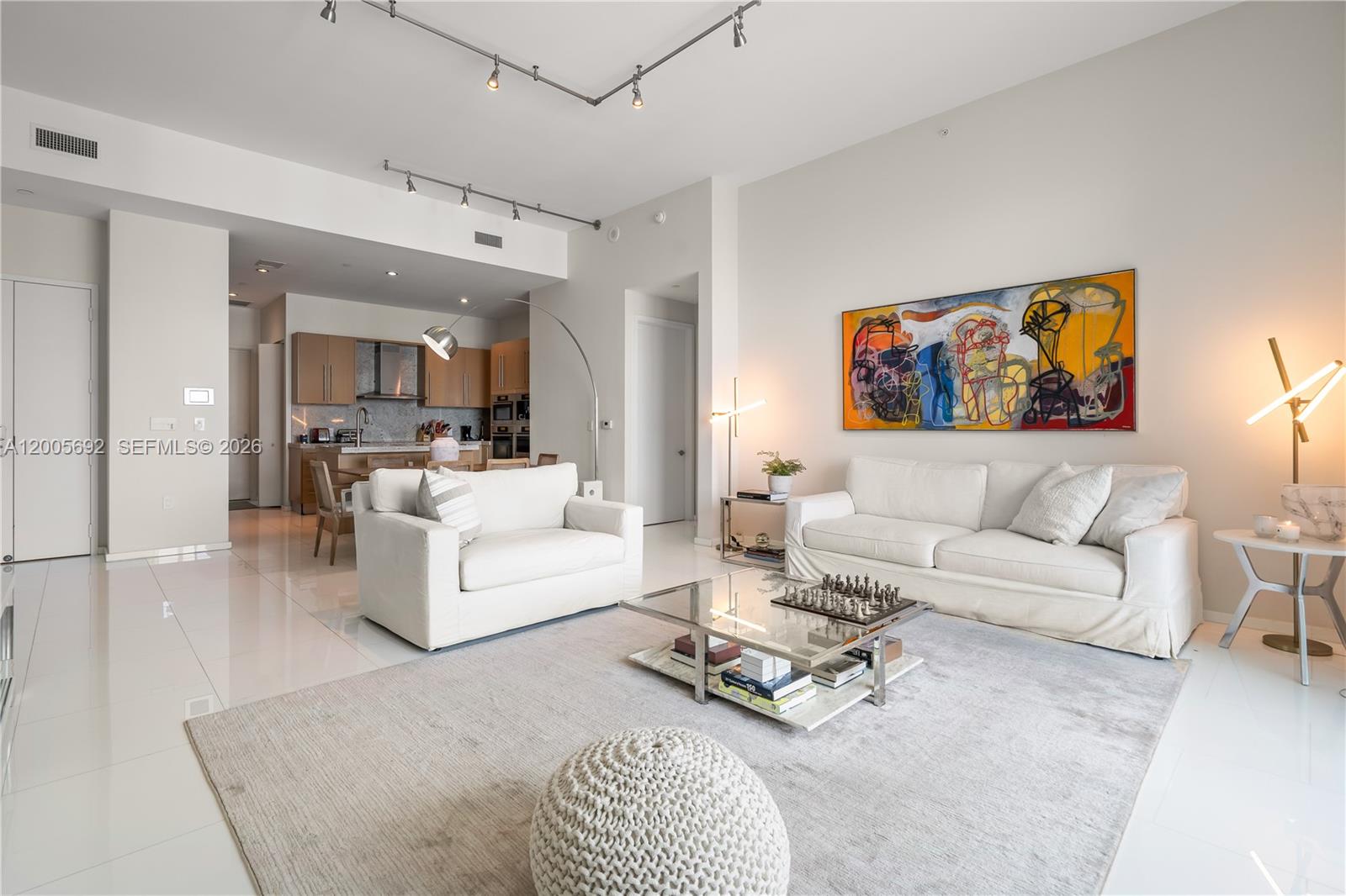 900 Brickell Key Boulevard, Unit 3002 Miami, FL 33131 - Photo 4 of 47 a living room with furniture a rug and kitchen view