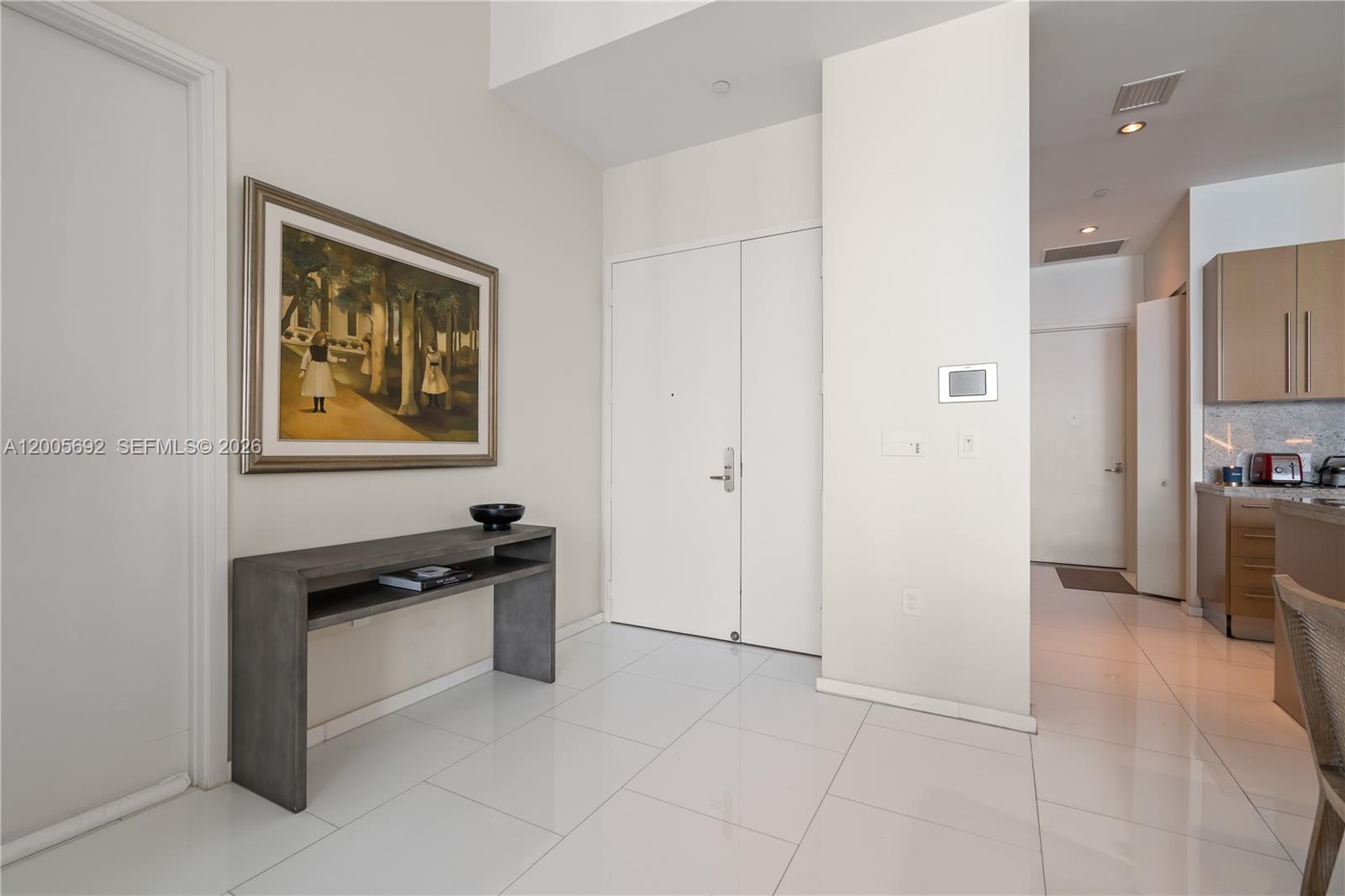 900 Brickell Key Boulevard, Unit 3002 Miami, FL 33131 - Photo 41 of 47 a view of a kitchen with a sink and dishwasher a refrigerator with wooden floor