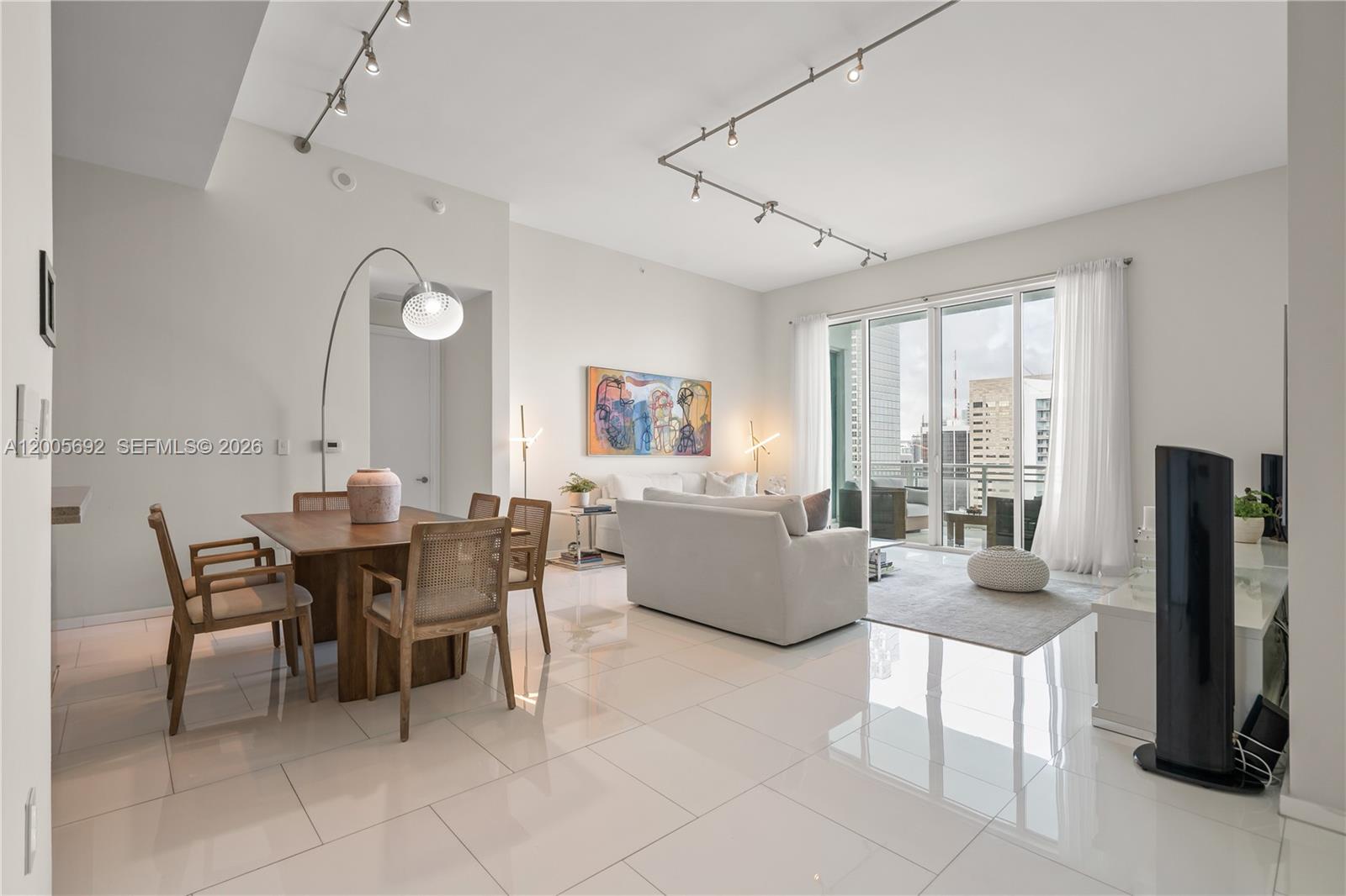 900 Brickell Key Boulevard, Unit 3002 Miami, FL 33131 - Photo 7 of 47 a view of a dining room with furniture and a large window