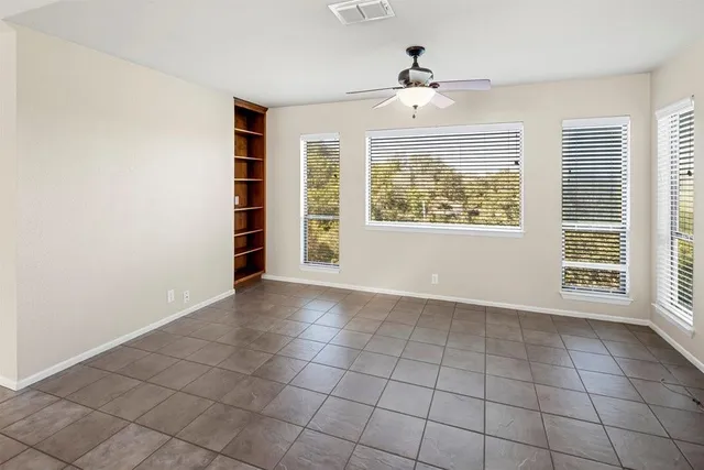 an empty room with windows and closet