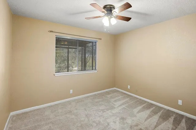 a view of a room with wooden floor and iron stairs