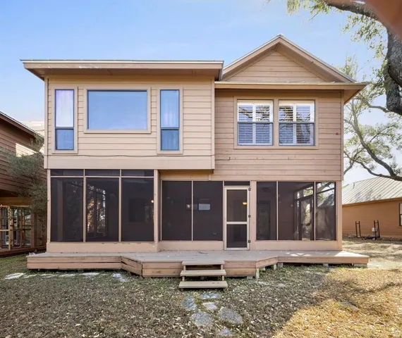 a view of a backyard with large trees