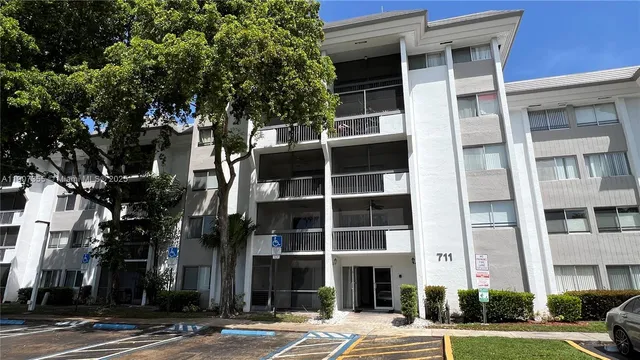 a view of a park with a bench under palm trees