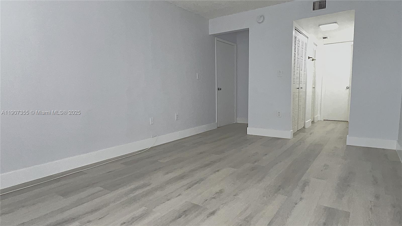 711 North Pine Island Road, Unit 415 Plantation, FL 33324 - Photo 12 of 19 a view of an empty room with wooden floor