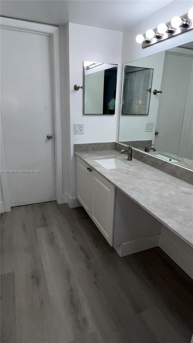 711 North Pine Island Road, Unit 415 Plantation, FL 33324 - Photo 13 of 19 a spacious bathroom with a double vanity sink and mirror