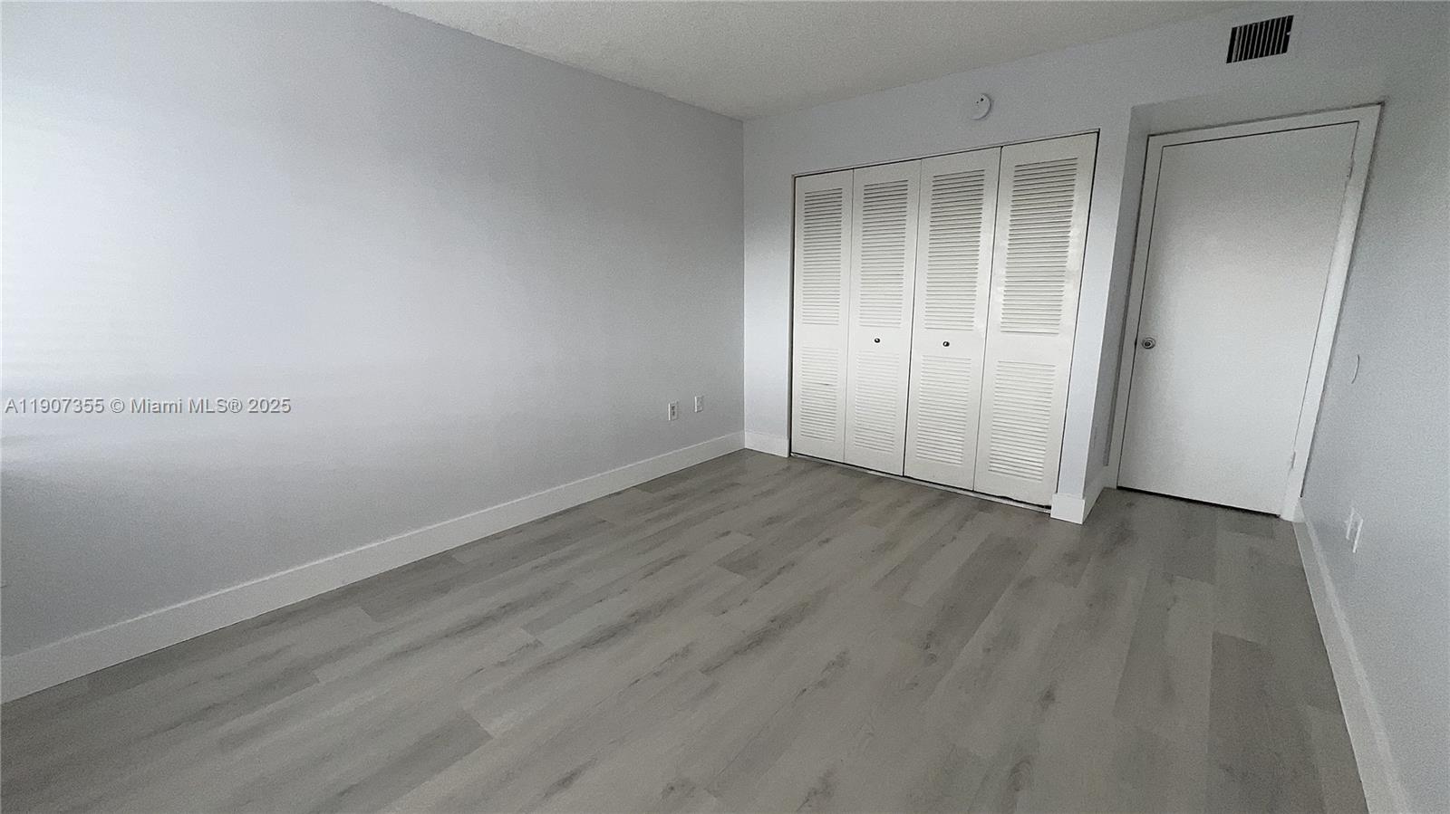 711 North Pine Island Road, Unit 415 Plantation, FL 33324 - Photo 14 of 19 wooden floor in an empty room
