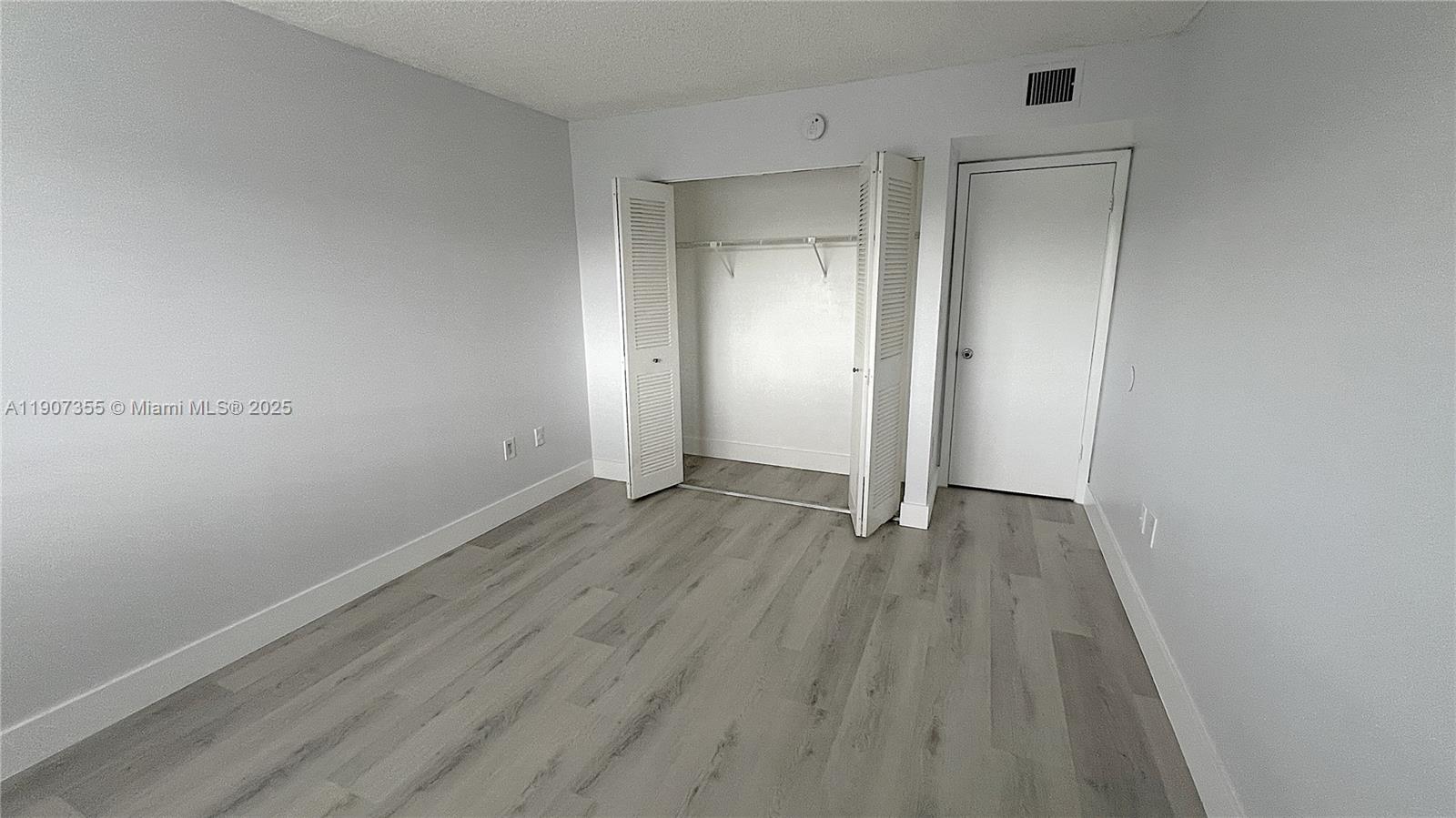 711 North Pine Island Road, Unit 415 Plantation, FL 33324 - Photo 15 of 19 a view of an empty room with wooden floor