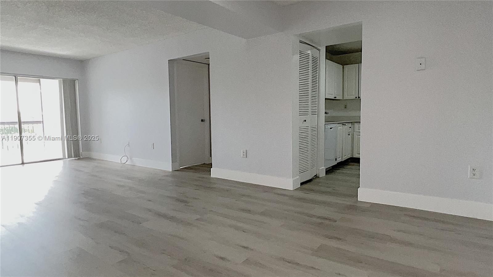 711 North Pine Island Road, Unit 415 Plantation, FL 33324 - Photo 3 of 19 an empty room with wooden floor and windows