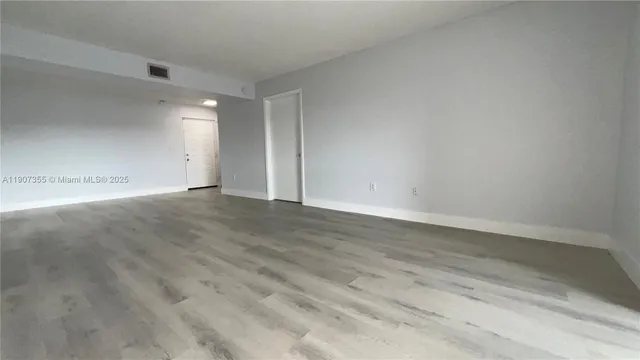 a view of balcony with wooden floor