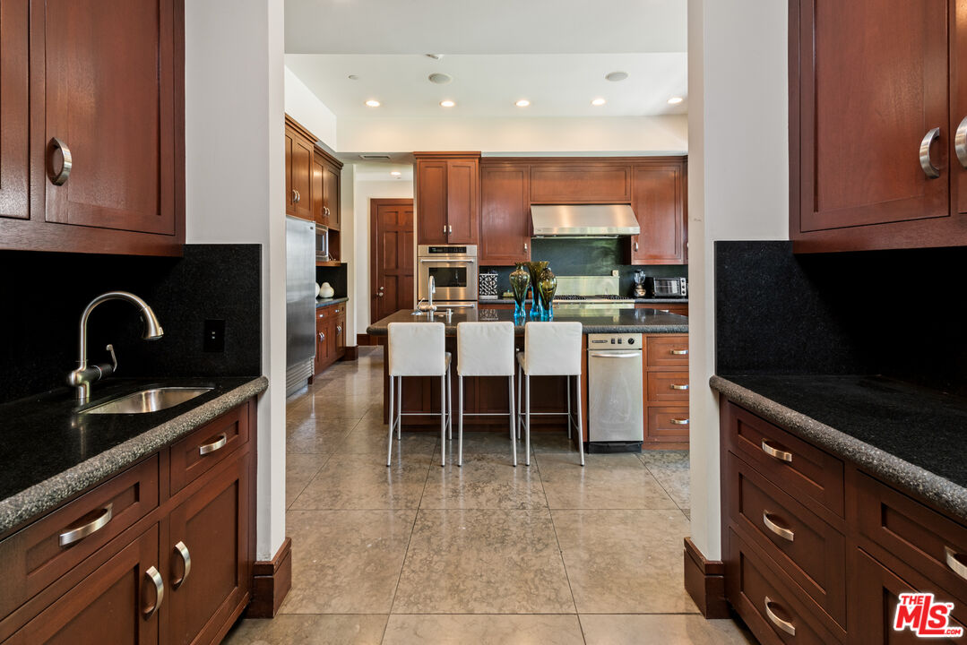 13947 Durham Road Beverly Hills, CA 90210 - Photo 14 of 46 a kitchen with stainless steel appliances granite countertop a stove and a microwave