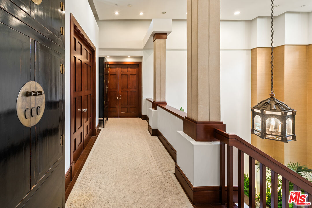 13947 Durham Road Beverly Hills, CA 90210 - Photo 20 of 46 a hallway with wooden door