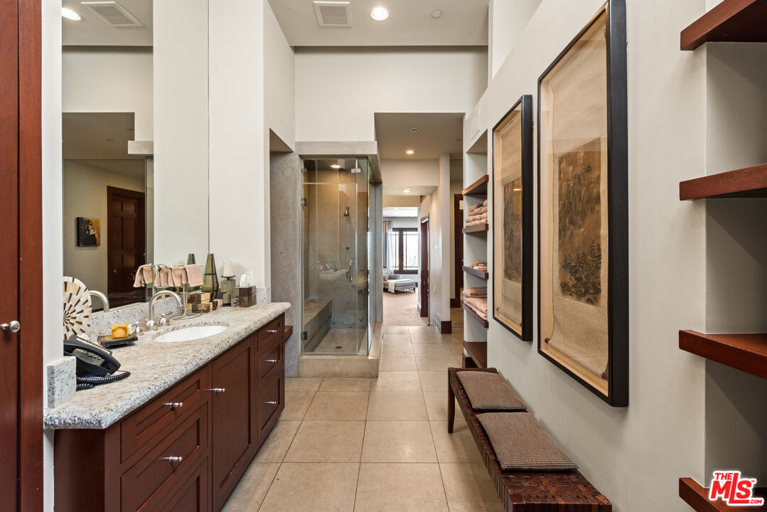 13947 Durham Road Beverly Hills, CA 90210 - Photo 29 of 46 a spacious bathroom with a double vanity sink and a mirror