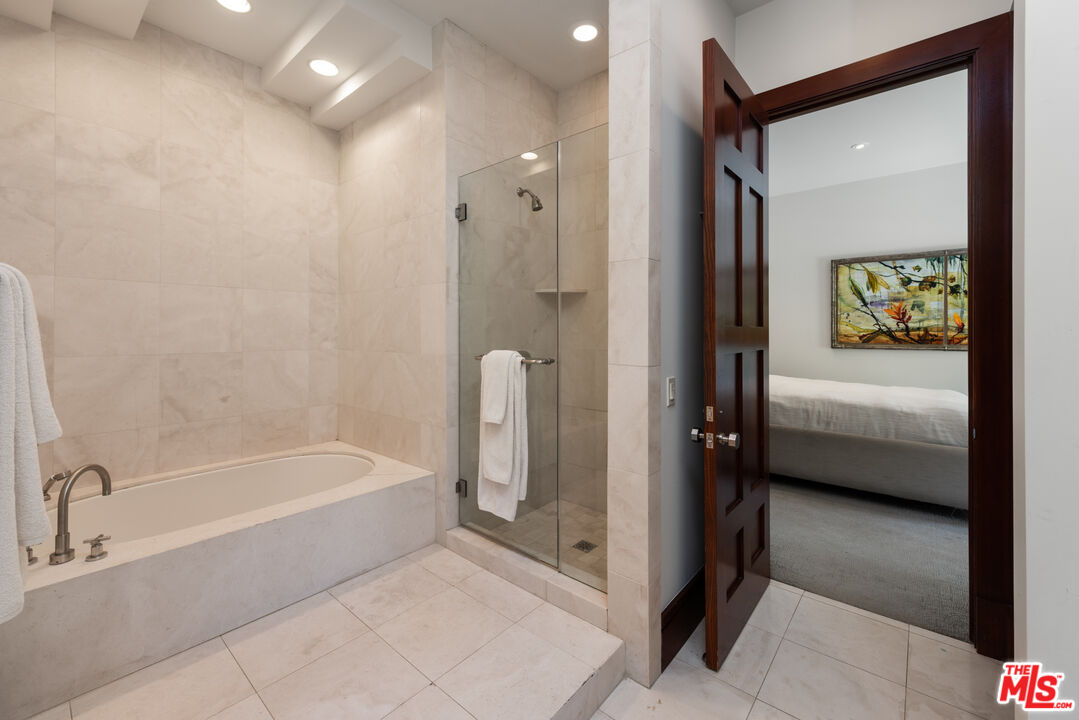 13947 Durham Road Beverly Hills, CA 90210 - Photo 31 of 46 a en suite bathroom with a tub shower and sink