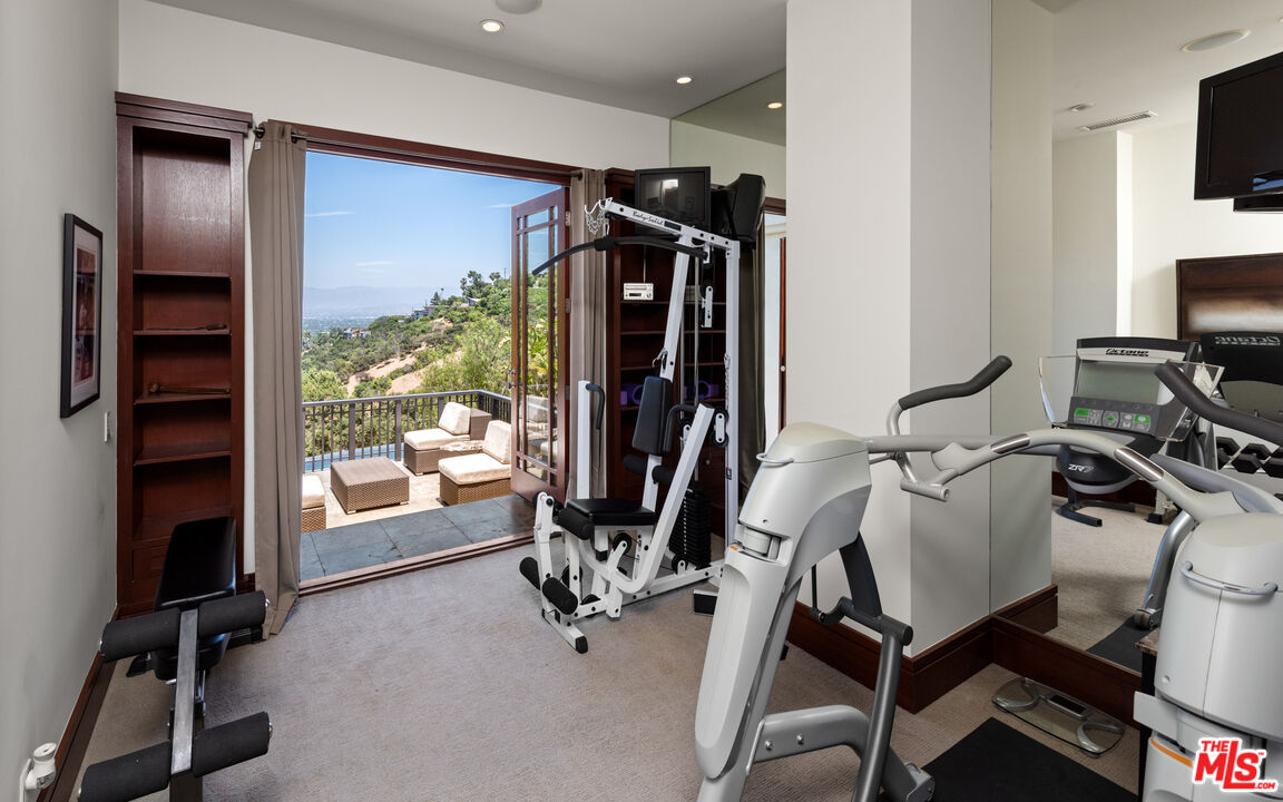 13947 Durham Road Beverly Hills, CA 90210 - Photo 34 of 46 a view of a room with gym equipment