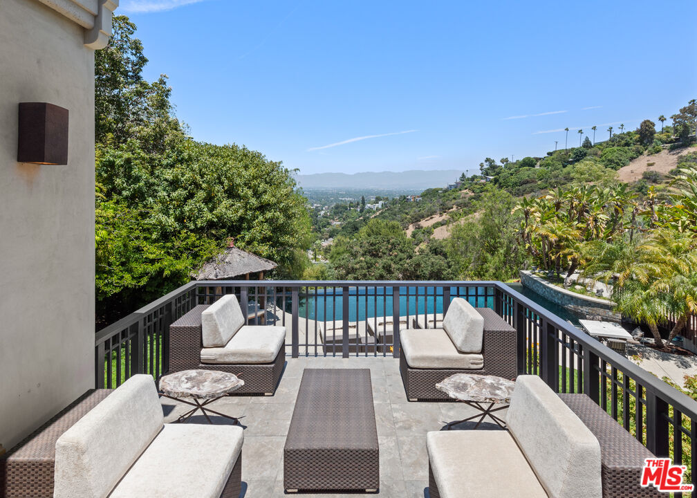 13947 Durham Road Beverly Hills, CA 90210 - Photo 35 of 46 a view of a balcony with two chairs and a table