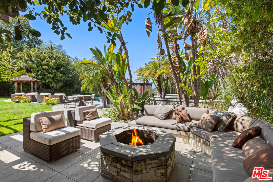 13947 Durham Road Beverly Hills, CA 90210 - Photo 37 of 46 a view of a backyard with couches and a fire pit