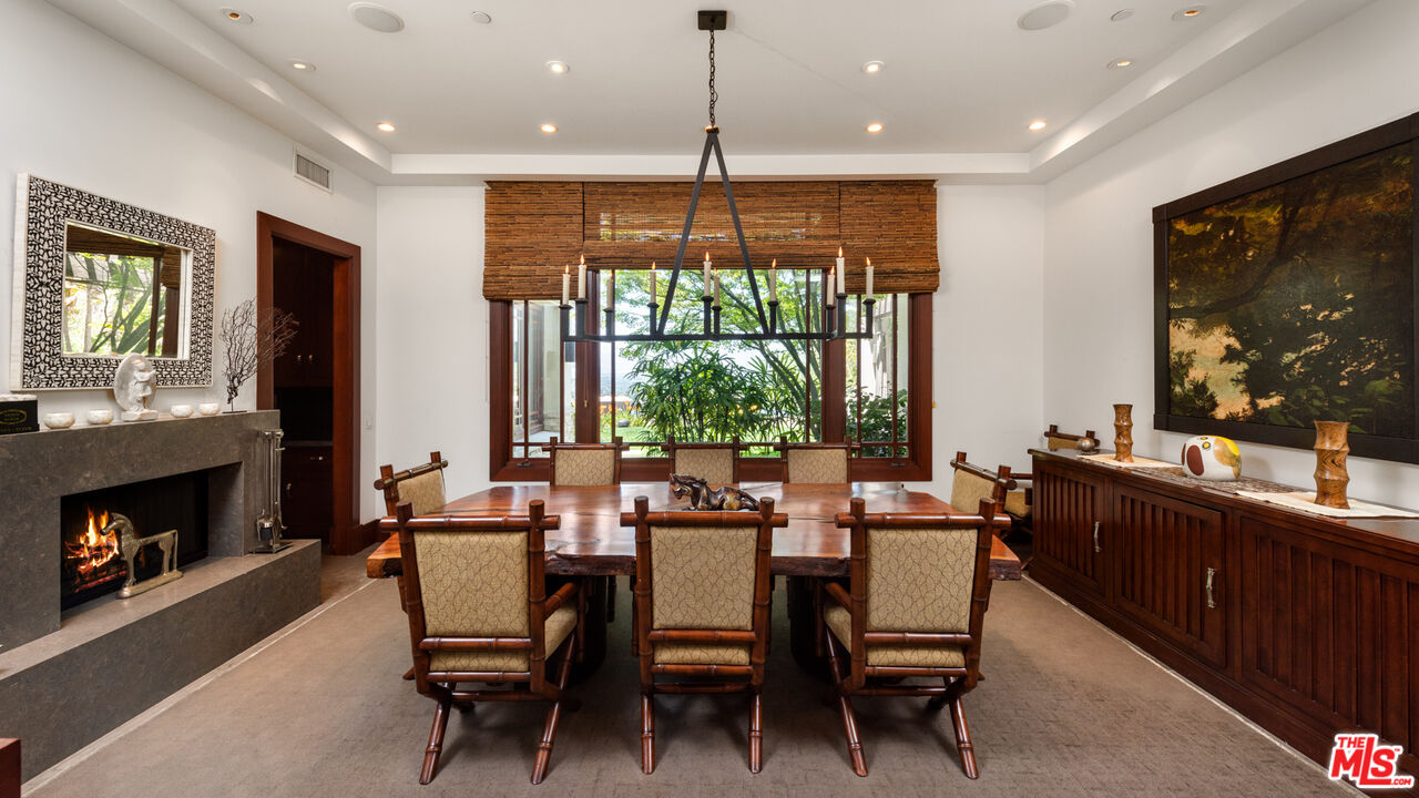13947 Durham Road Beverly Hills, CA 90210 - Photo 9 of 46 a dining room with furniture a window and a fireplace