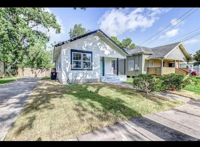 a front view of a house with a yard outdoor seating and garage