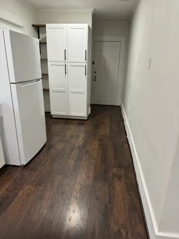 a view of a refrigerator in kitchen and wooden floor