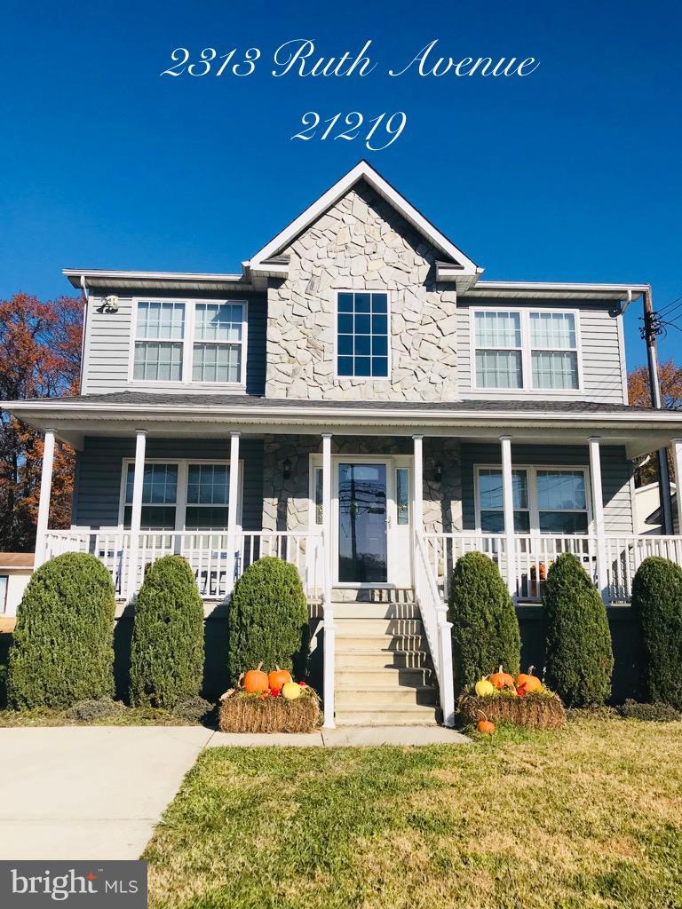 2313 Ruth Avenue Baltimore, MD 21219 - Photo 2 of 25 a front view of a house with yellow lighting