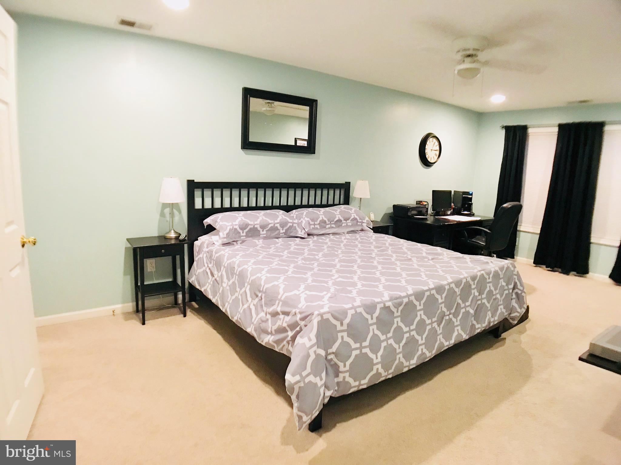 2313 Ruth Avenue Baltimore, MD 21219 - Photo 11 of 25 a bedroom with a bed and a wall painting
