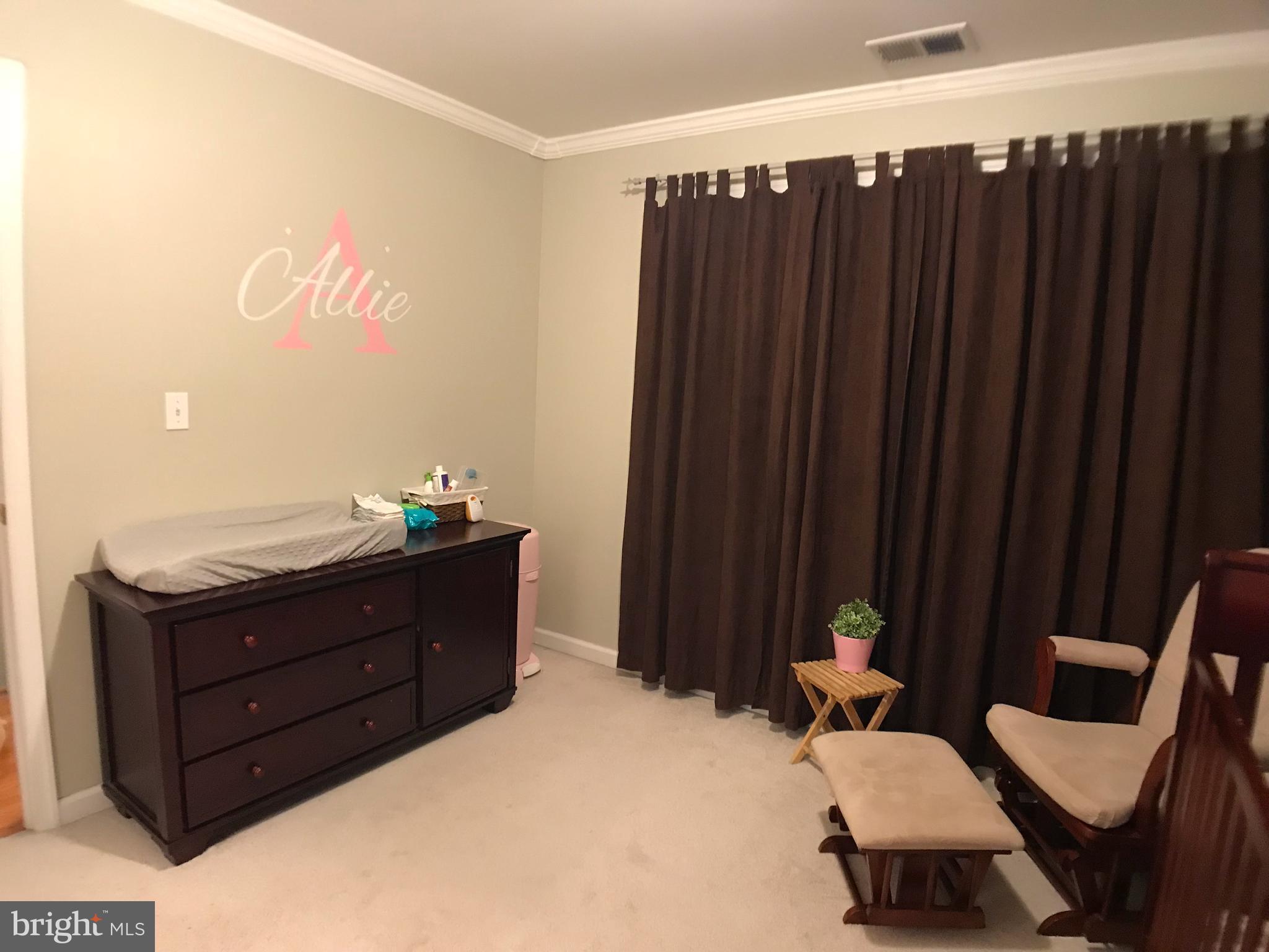 2313 Ruth Avenue Baltimore, MD 21219 - Photo 18 of 25 a room with a bed and furniture