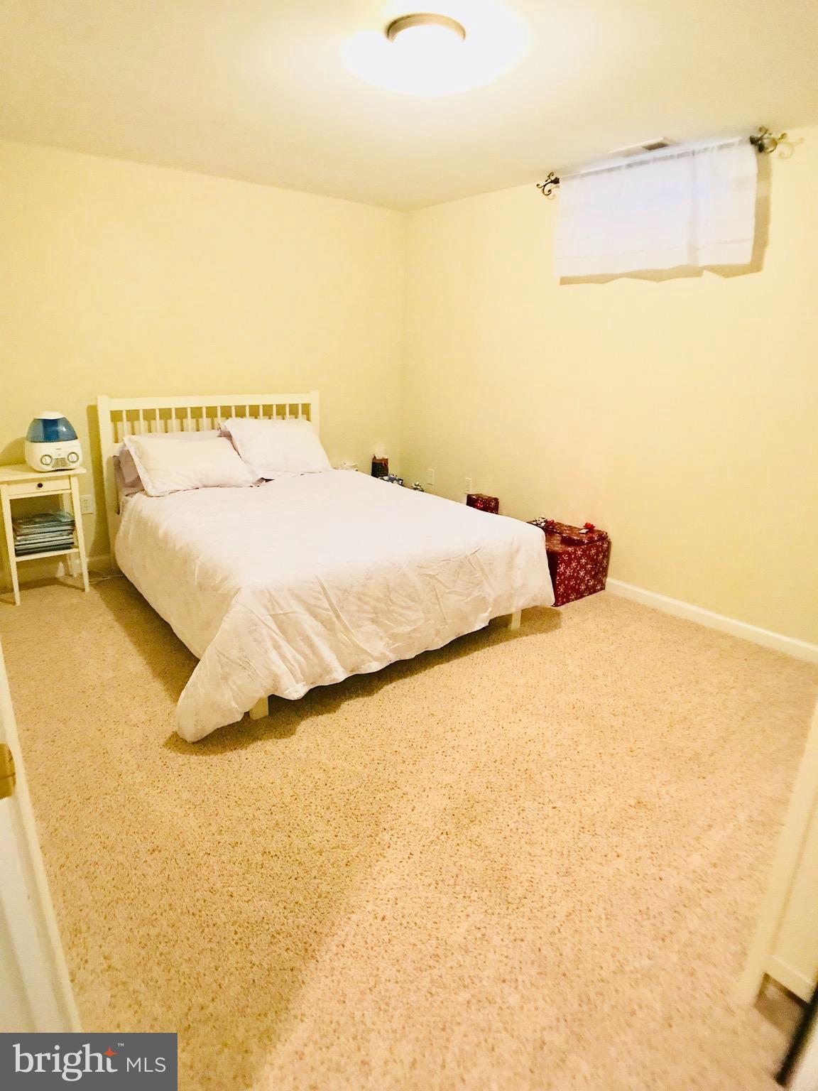 2313 Ruth Avenue Baltimore, MD 21219 - Photo 19 of 25 a bedroom with a bed and a wall painting